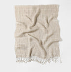 Plaid linen scarf shown draped, the white check grid following the folds of the cloth