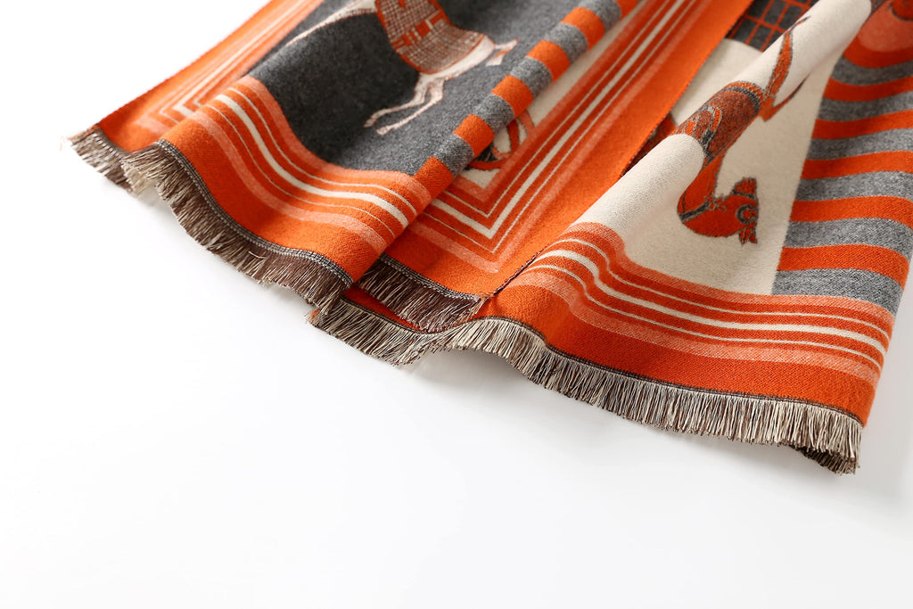 Close view of the frayed fringed end of the orange horse print shawl