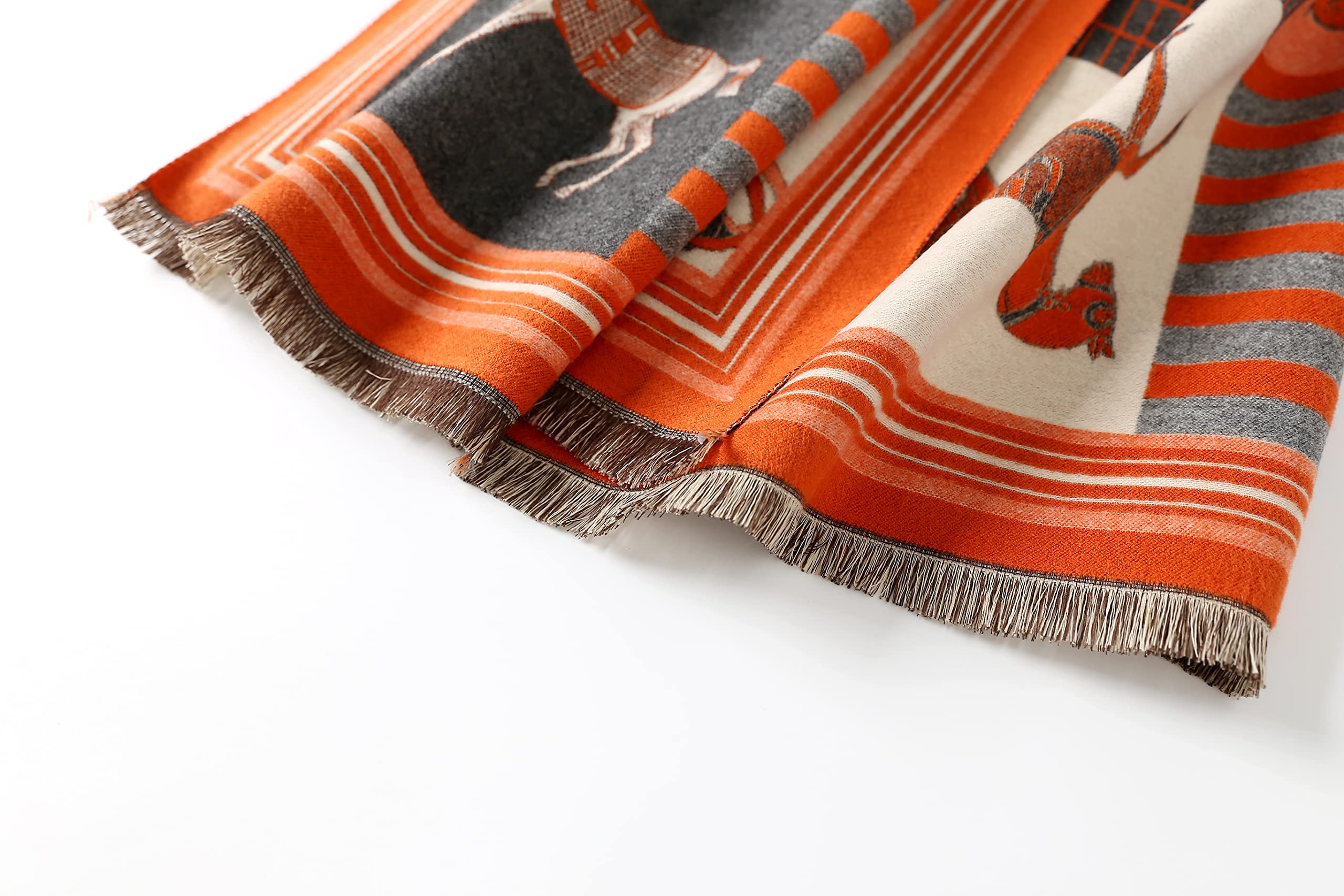 Close view of the frayed fringed end of the orange horse print shawl