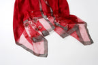 Angled view of the red embroidered end with the metallic woven border