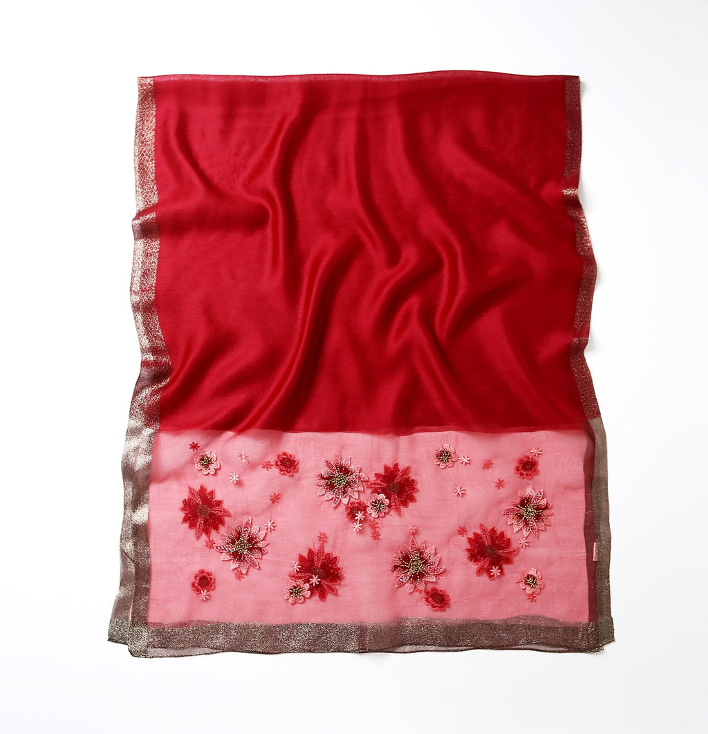 Red shawl folded flat showing full width and the beaded band along the bottom edge