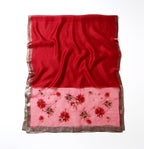Red shawl folded flat showing full width and the beaded band along the bottom edge