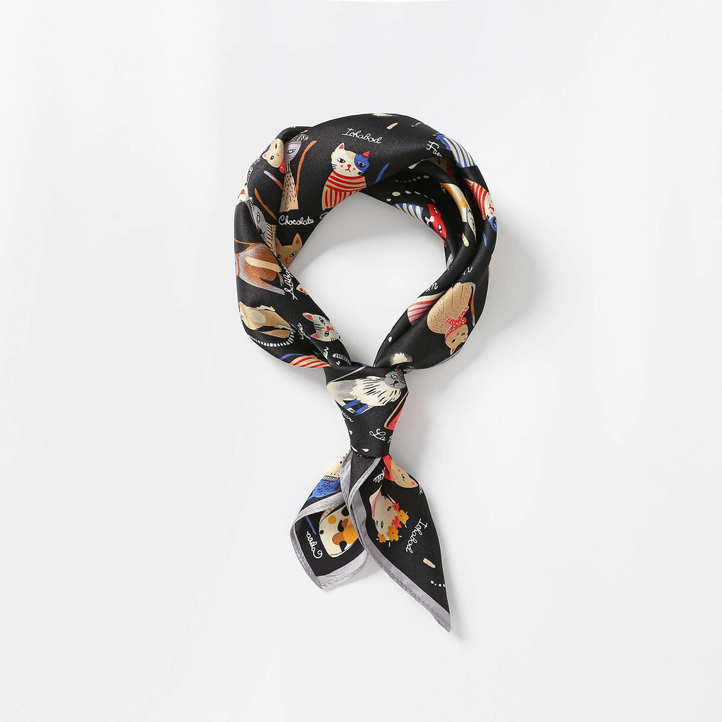 Cat print silk square knotted into a neat standing loop with the tails crossing in front
