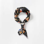 Cat print silk square knotted into a neat standing loop with the tails crossing in front