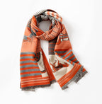 Horse print shawl looped once around the neck with the fringed ends hanging down the front