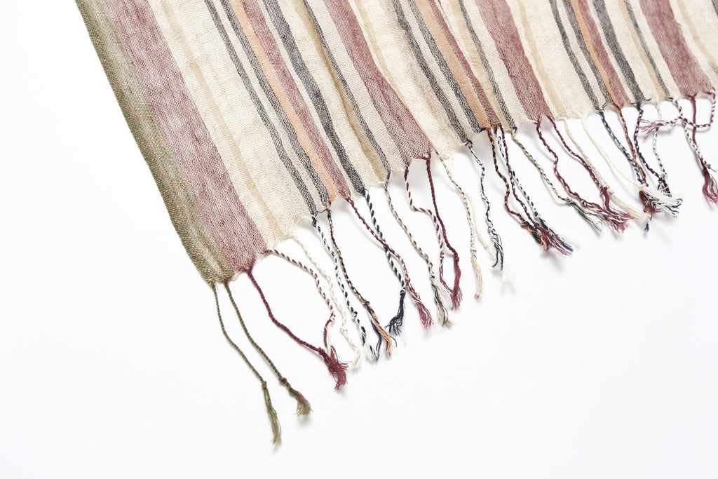 Fabric close up showing oat cocoa and charcoal stripes and the open cotton linen weave