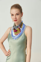 Model in sage satin with the striped-border square folded into a V at the neck