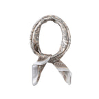 Cream silk square in taupe paisley knotted into a neck loop, pale grey satin border