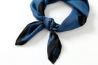 Steel blue dotted silk knotted at the front, black bordered tails fanned out on white