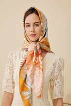 Close portrait of the tangerine rainforest silk headscarf with palm and coral print