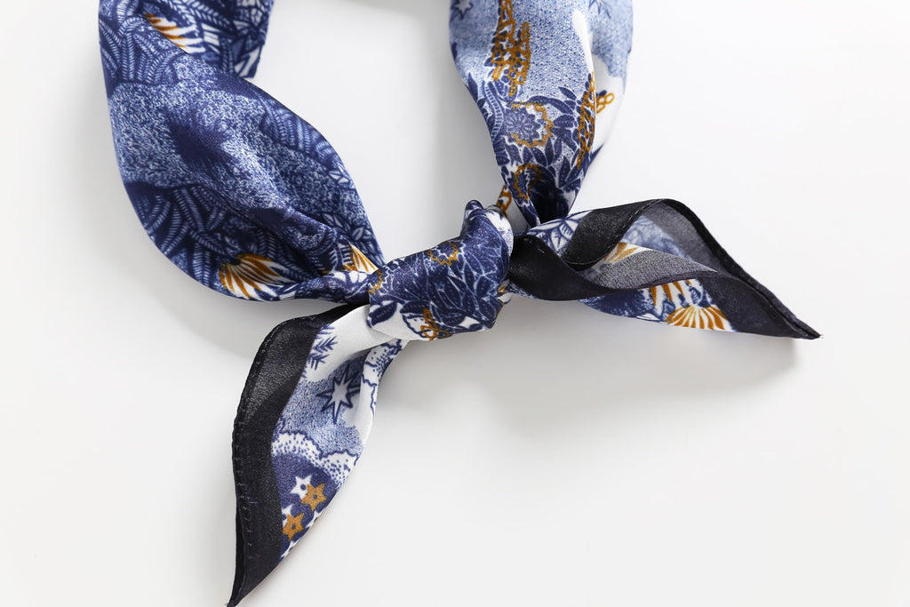 Toile square twisted into a band and tied, black border running down the tails