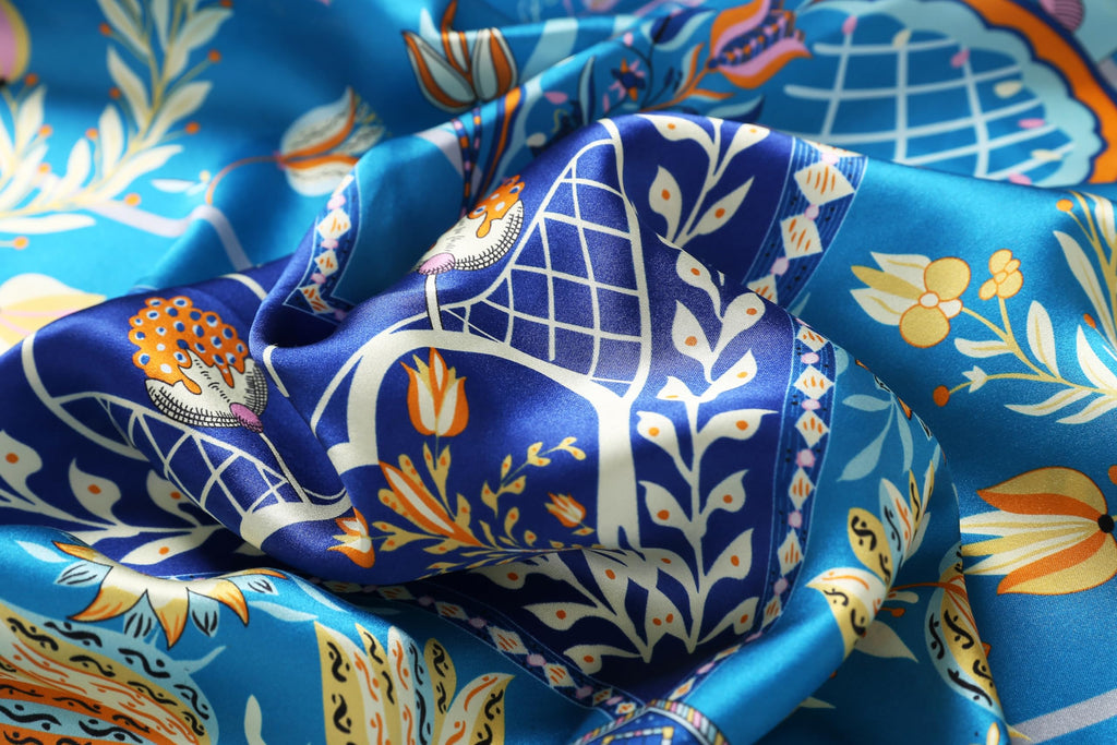 Detail of tulips daisies and lattice motifs in yellow and coral on cobalt