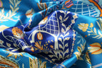 Detail of tulips daisies and lattice motifs in yellow and coral on cobalt