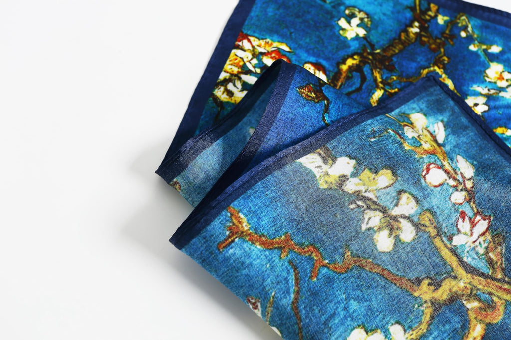 Corner fold showing the navy border band against the almond blossom print
