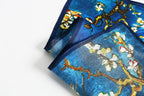 Corner fold showing the navy border band against the almond blossom print