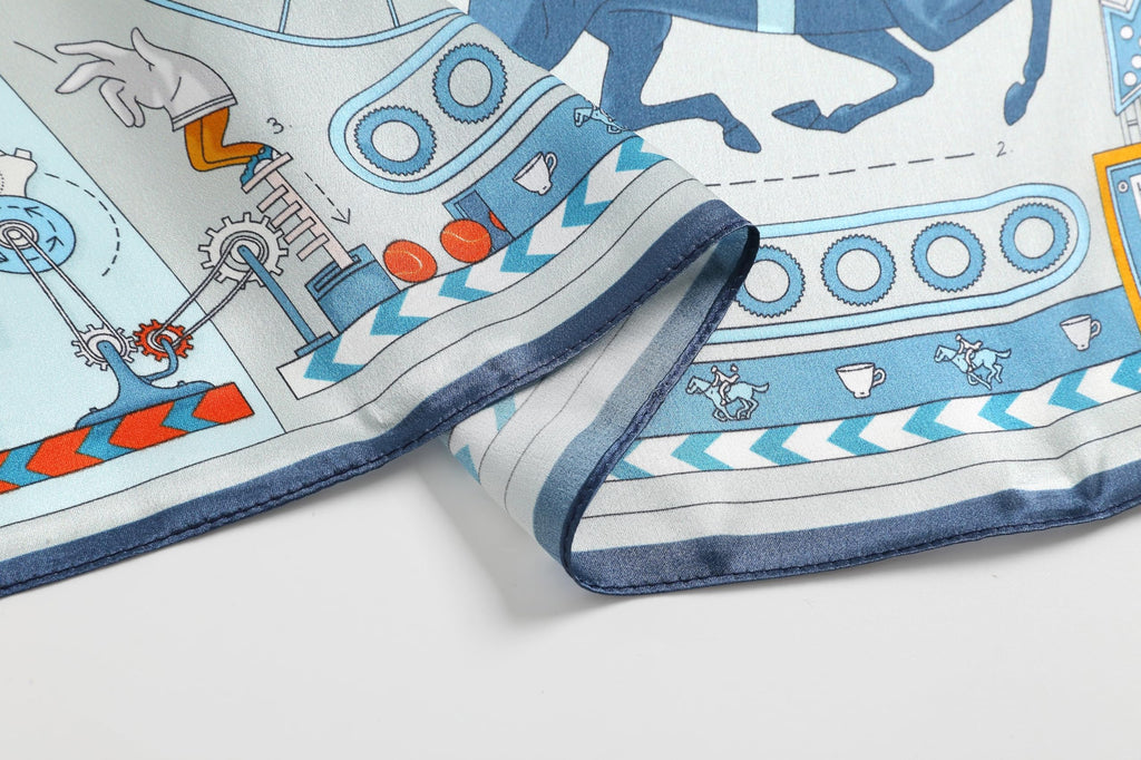 Edge detail, the navy border band and rolled hem beside blue machinery drawings