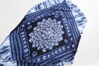 Detail of the Jeelow indigo batik scarf centre panel, a large white rosette medallion on navy inside a bordered frame of small floral motifs