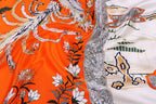 Close up of the orange panel with white floral engraving detail
