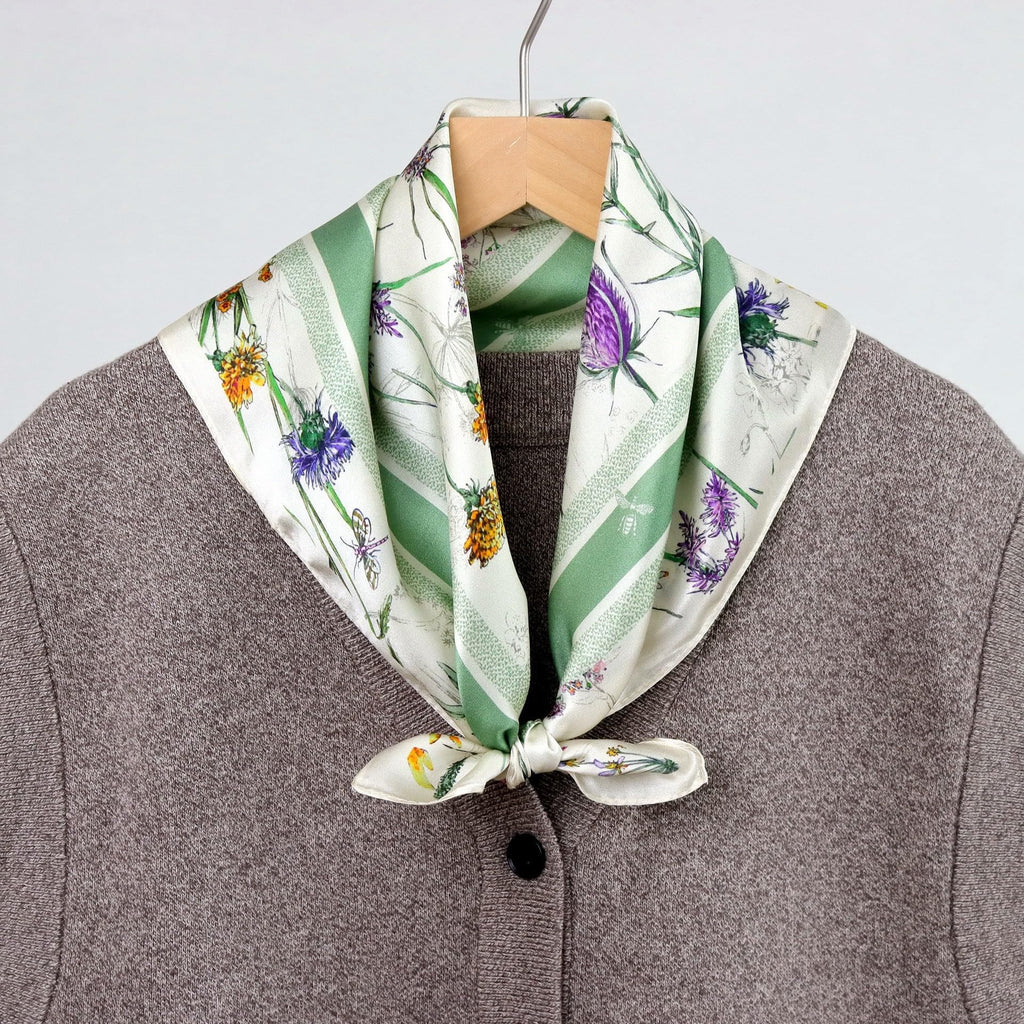 Wildflower square tied at the collar of a brown wool coat on a hanger