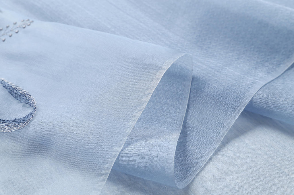 Close up of the crinkled sheer blue fabric and its subtle sheen