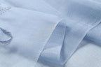 Close up of the crinkled sheer blue fabric and its subtle sheen