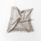 Full cream paisley square opened flat, centre pinched up, grey border on four sides