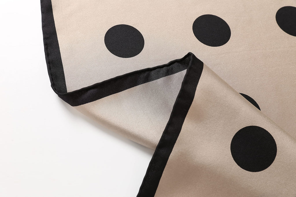Detail of the greige square's black border and narrow hand rolled hem at the corner
