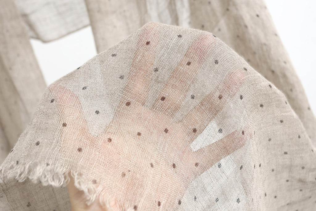 Detail of the frayed self fringe on the polka dot linen scarf
