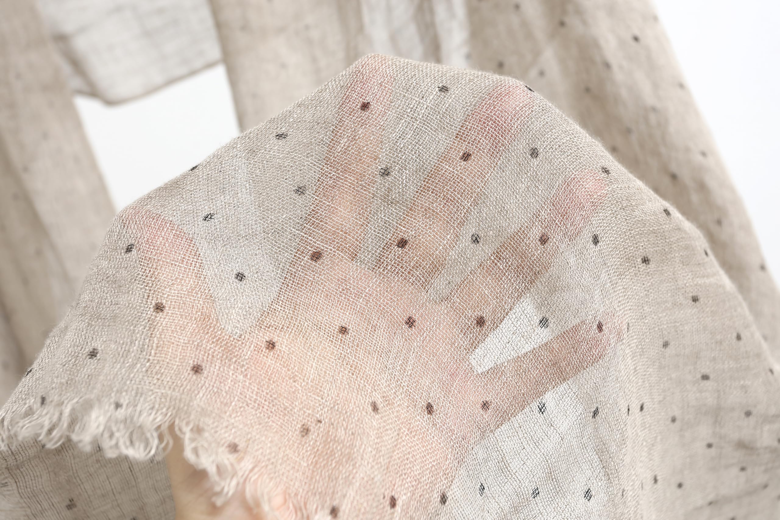 Detail of the frayed self fringe on the polka dot linen scarf