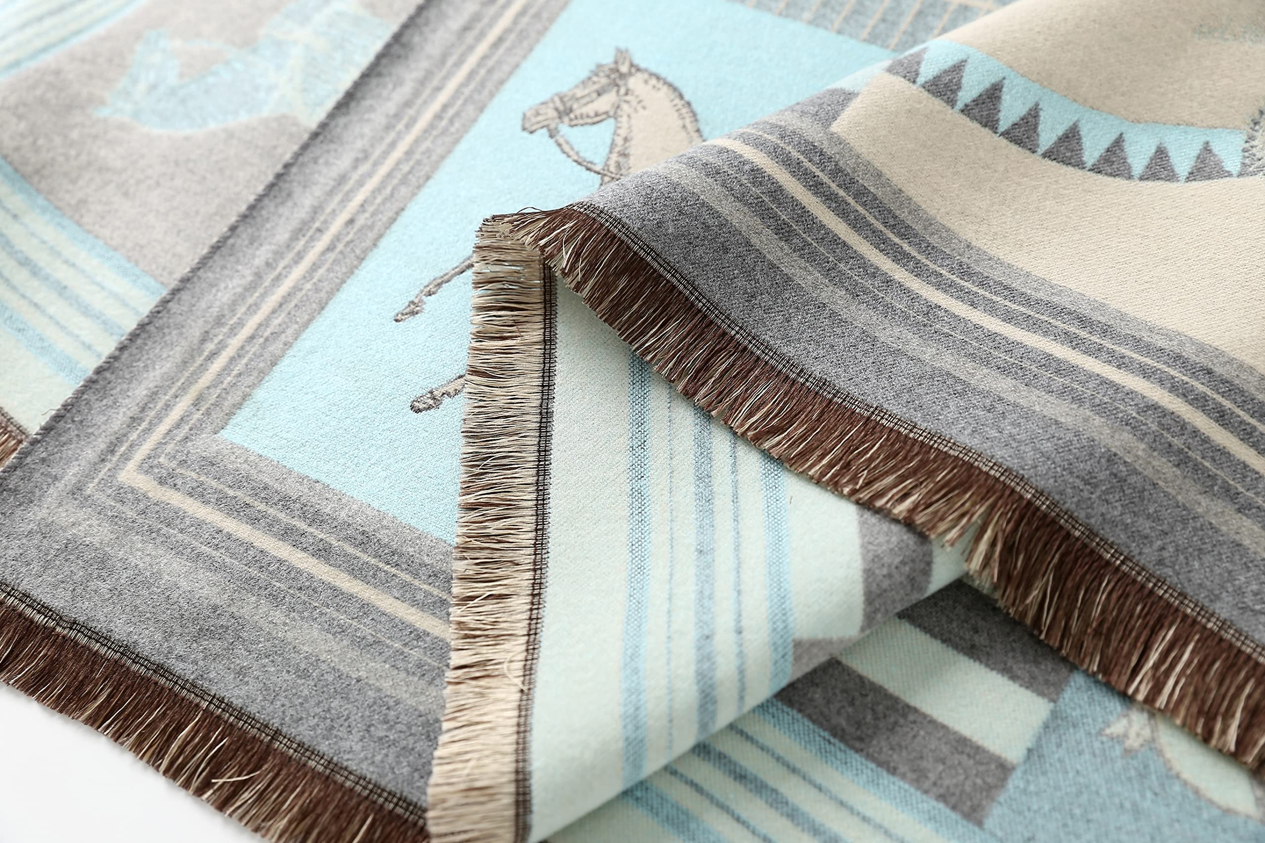 Close view of the folded corner showing the brown fringe and the triangle border detail