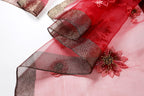 Close up of the metallic woven border beside a beaded bloom