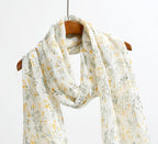 Detail of the frayed self fringe on the yellow botanical linen scarf