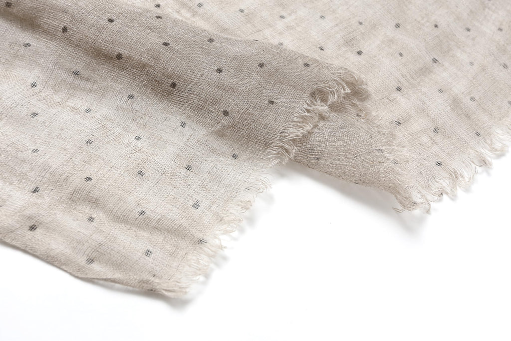 Polka dot linen scarf worn looped at the neck