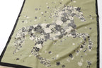 Flat detail of the floral horse motif filling the centre panel against the sage ground