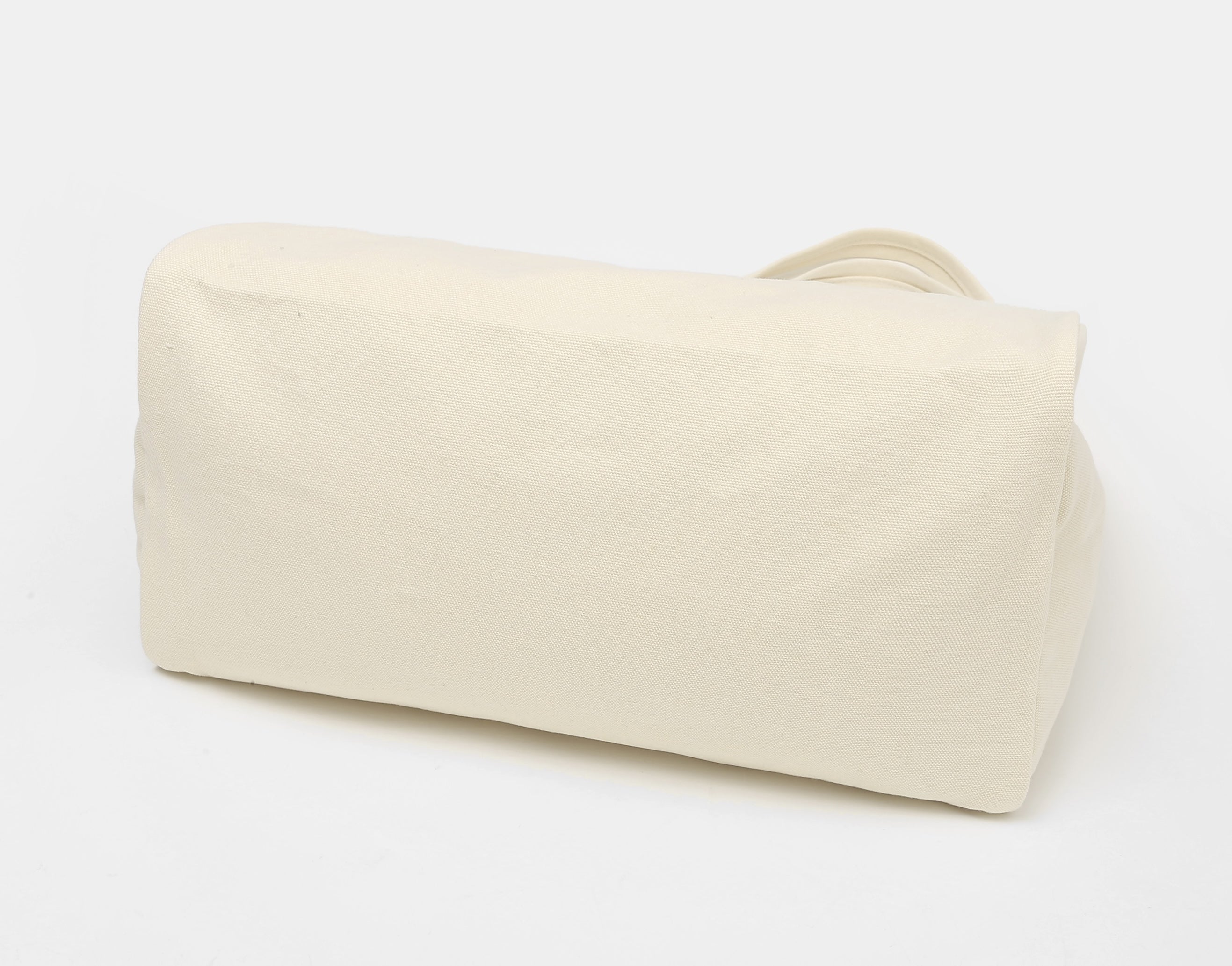 Folded cream canvas tote bag bottom view