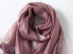 Close-up of embroidered poppies with beaded centers on mauve scarf