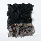 Black Jeelow scarf shown with metallic woven border detail