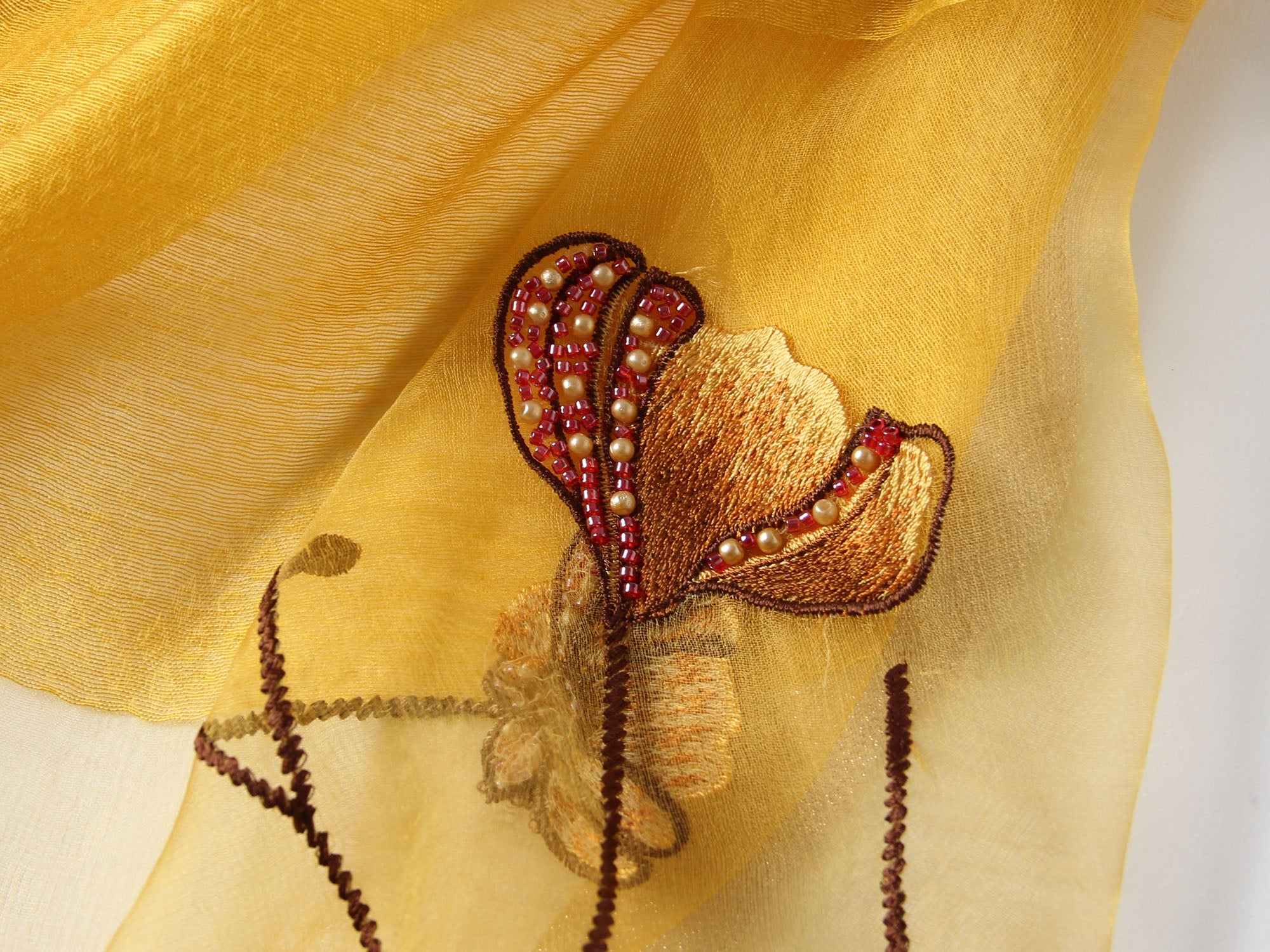 Long semi-sheer champagne wrap with embroidered poppies — model view